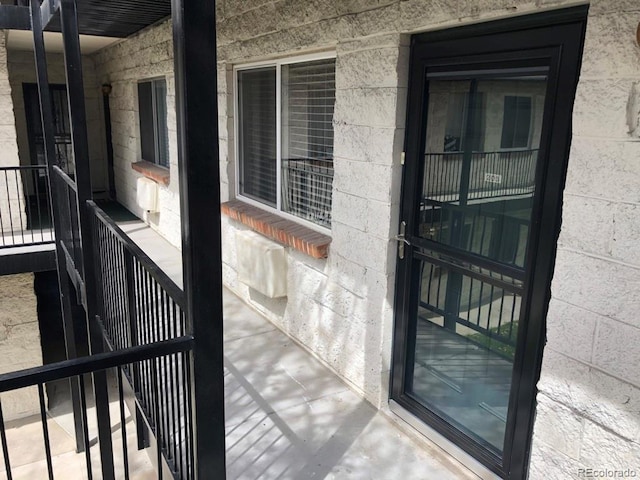 5875 E Iliff Ave Unit 203, Denver, CO 80222 - view of exterior entry featuring concrete block siding
