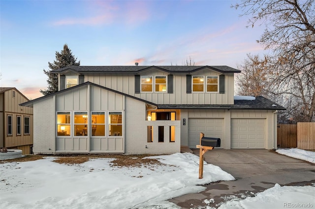 snow covered house with a garage