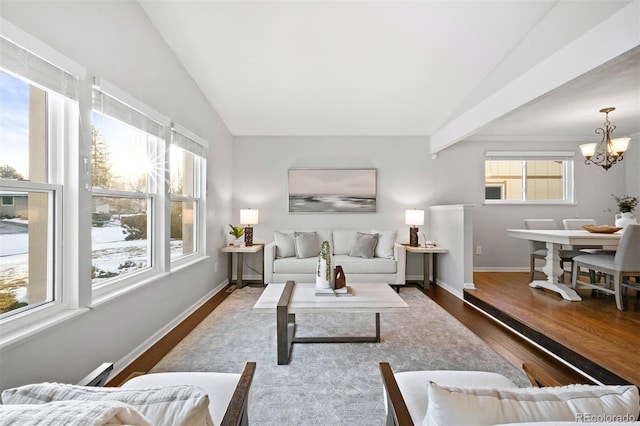 living room featuring lofted ceiling, wood-type flooring, and plenty of natural light