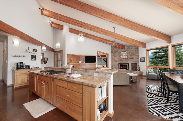 73244 US Highway 40, Tabernash, CO 80478 - kitchen featuring decorative light fixtures, stainless steel gas stovetop, open shelves, a large fireplace, and concrete floors