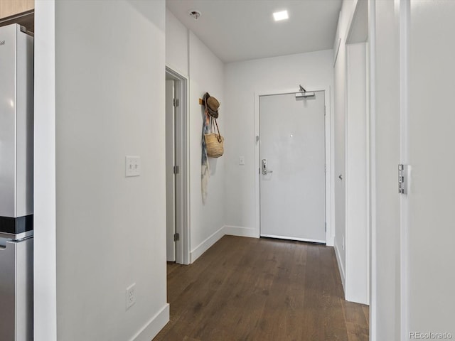 hallway with baseboards and dark wood finished floors