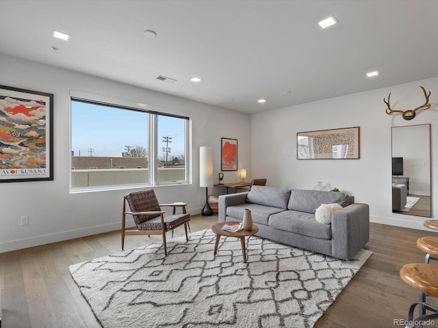 living room with baseboards, recessed lighting, wood finished floors, and visible vents