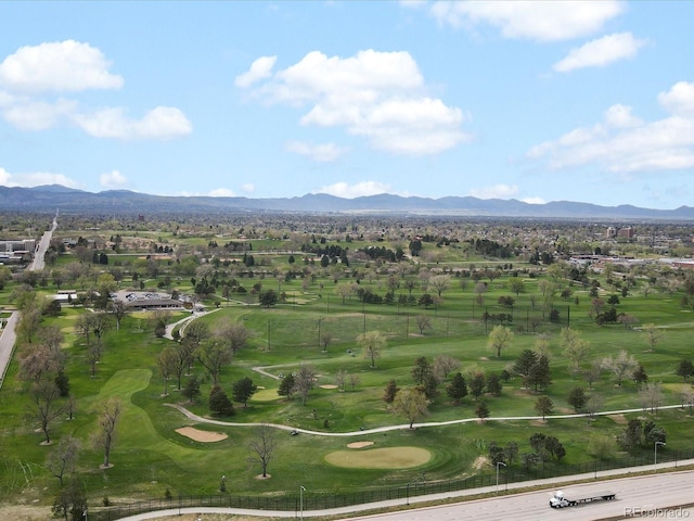 drone / aerial view with view of golf course, a residential view, and a mountain view