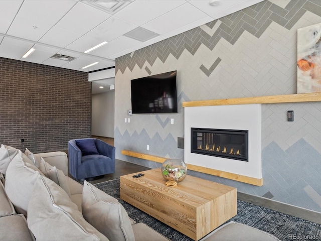 living area with visible vents and a glass covered fireplace