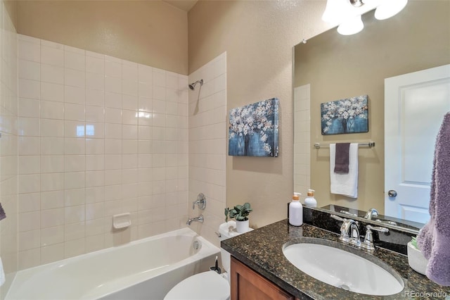 full bathroom featuring tiled shower / bath combo, toilet, and vanity