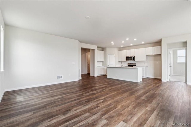 14406 Ranch St, Mead, CO 80504 - unfurnished living room featuring dark wood finished floors and recessed lighting
