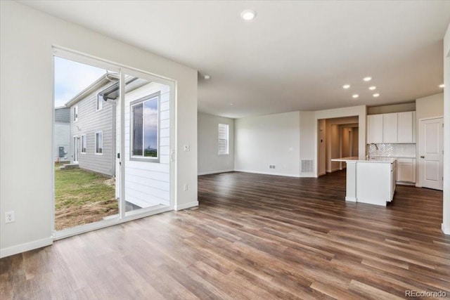 14406 Ranch St, Mead, CO 80504 - unfurnished living room with recessed lighting and dark wood-style flooring