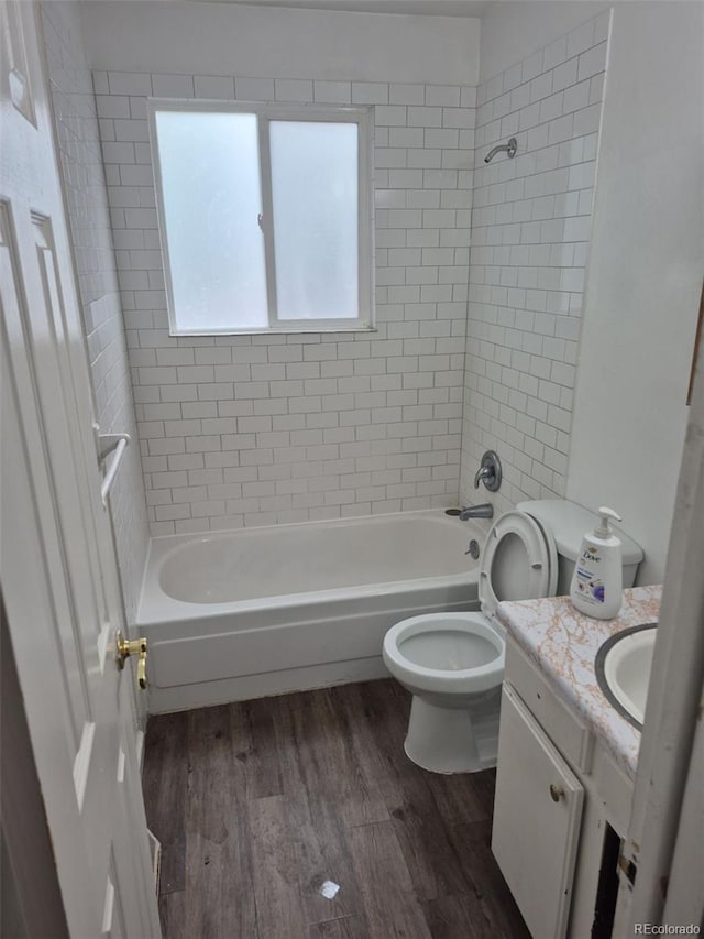 4678 S Lewiston Way, Aurora, CO 80015 - full bathroom with vanity, bathing tub / shower combination, wood finished floors, and toilet