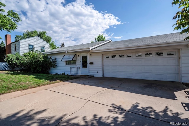 505 Maple St, Golden, CO 80403 - view of front of home with concrete driveway, a garage, and a front lawn