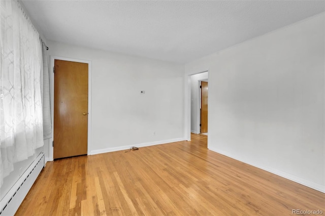 505 Maple St, Golden, CO 80403 - spare room featuring baseboard heating and light wood-style floors