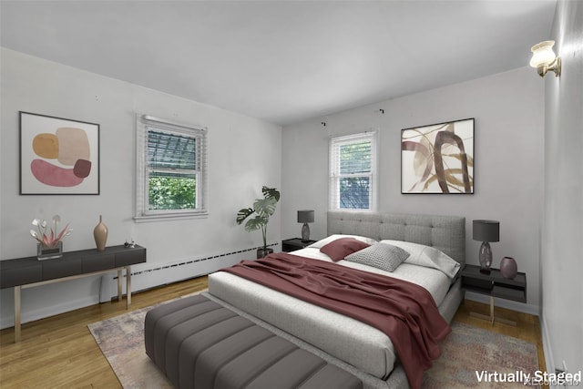 505 Maple St, Golden, CO 80403 - bedroom featuring a baseboard heating unit and wood finished floors