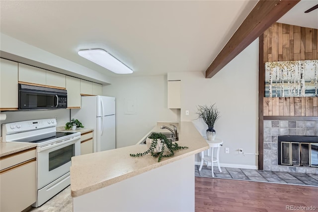 kitchen with a tile fireplace, sink, beamed ceiling, white appliances, and light wood-type flooring