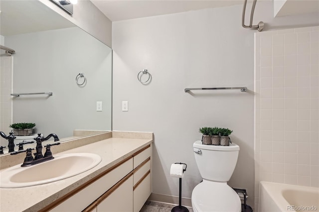 full bathroom featuring washtub / shower combination, vanity, and toilet