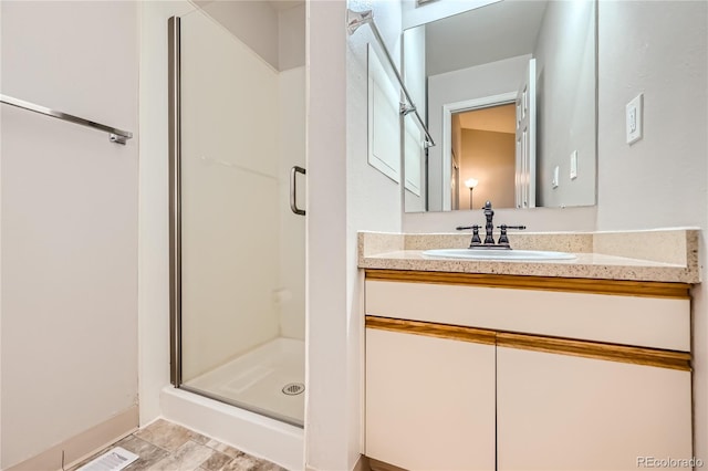 bathroom featuring vanity and a shower with shower door