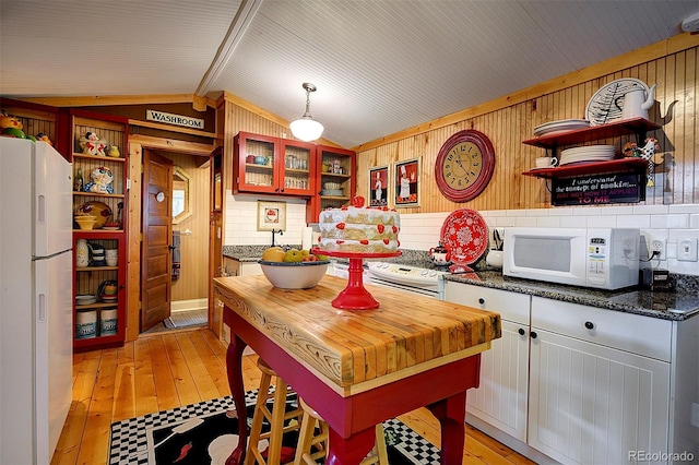 80 Meadow Ln, Bailey, CO 80421 - kitchen featuring open shelves, freestanding refrigerator, wooden walls, lofted ceiling, and light wood finished floors