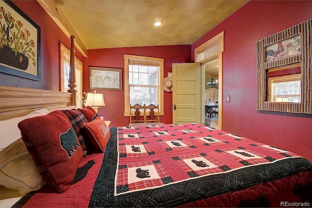 80 Meadow Ln, Bailey, CO 80421 - bedroom featuring vaulted ceiling and a textured wall
