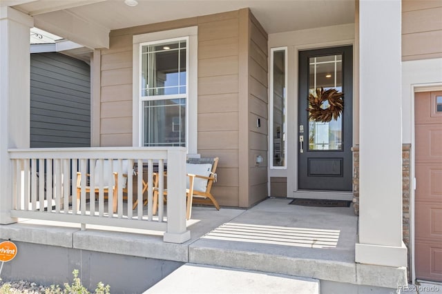 property entrance with a garage and covered porch