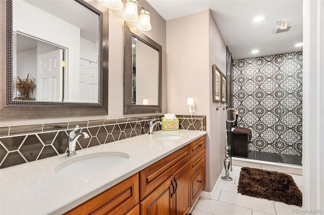 bathroom with vanity, backsplash, tile patterned flooring, and tiled shower