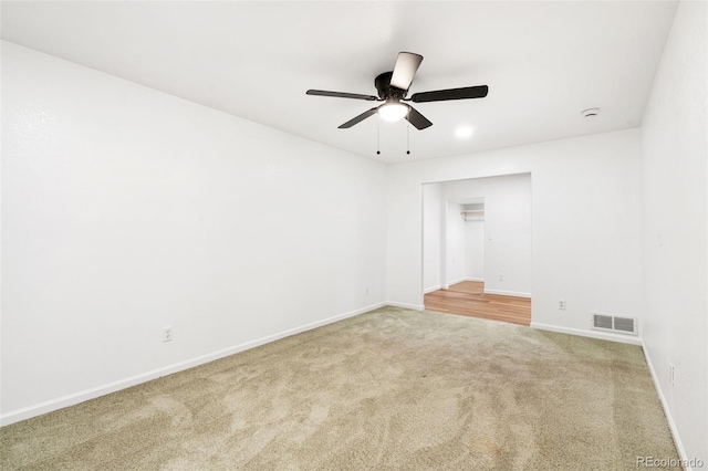 spare room featuring carpet floors and ceiling fan