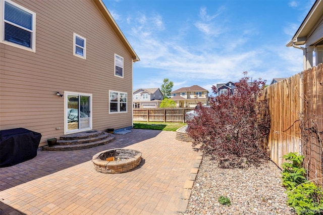 8004 Brittinger Way, Colorado Springs, CO 80951 - fenced backyard with a patio area, a fire pit, and a residential view
