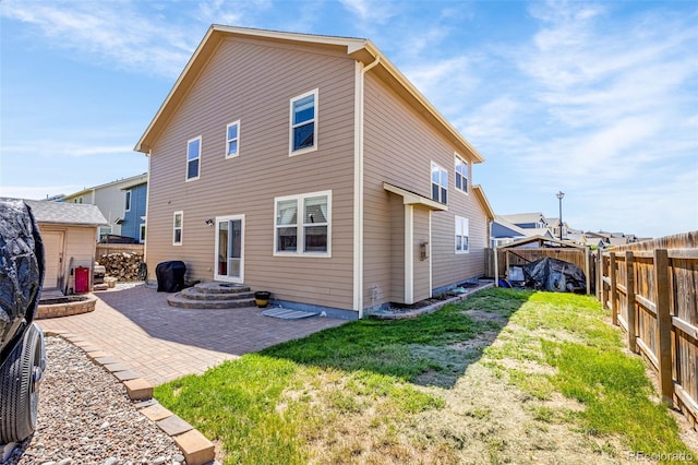 8004 Brittinger Way, Colorado Springs, CO 80951 - back of property featuring a patio area, a fenced backyard, and an outbuilding
