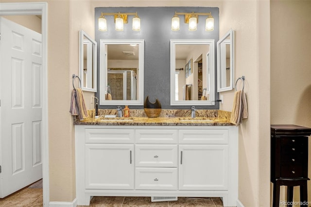 8004 Brittinger Way, Colorado Springs, CO 80951 - bathroom with double vanity, a shower with door, and tile patterned floors