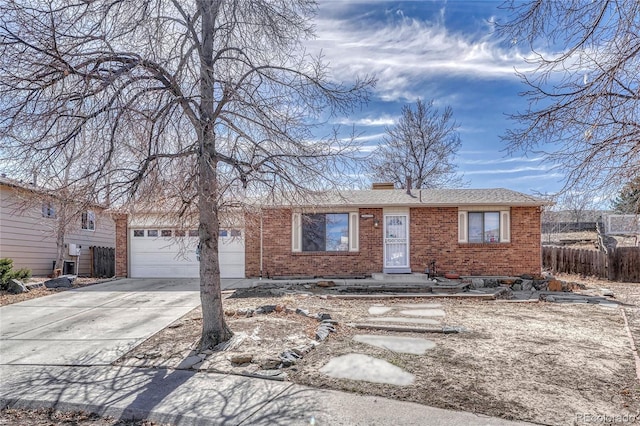 view of front of property with a garage, driveway, fence, and brick siding