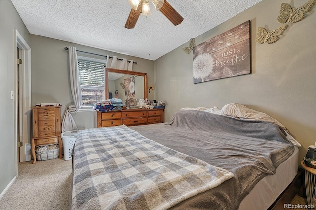 bedroom featuring carpet floors, a ceiling fan, and a textured ceiling