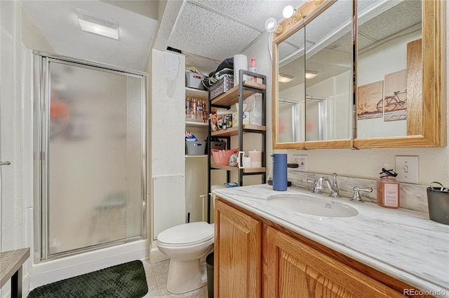 full bath with toilet, a stall shower, vanity, and a paneled ceiling