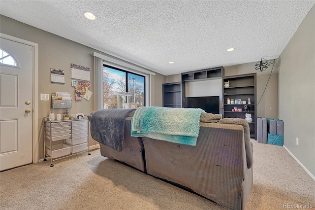 interior space with baseboards, a textured ceiling, and recessed lighting