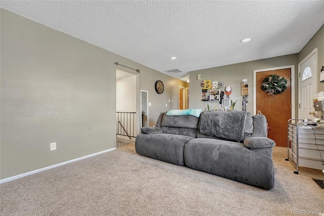 living area featuring baseboards, visible vents, a textured ceiling, carpet flooring, and recessed lighting