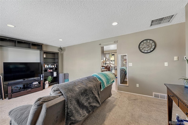 carpeted living area with recessed lighting, visible vents, and a textured ceiling