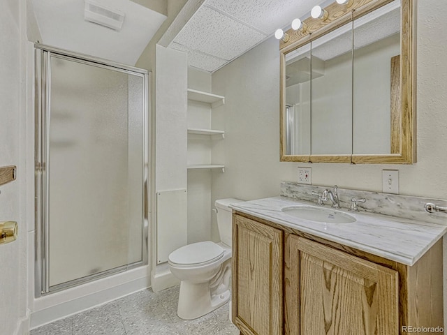 bathroom with vanity, visible vents, a shower stall, and toilet