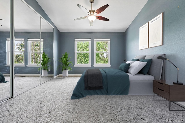 3300 W Florida Ave Unit 117, Denver, CO 80219 - carpeted bedroom with multiple windows, vaulted ceiling, a ceiling fan, and baseboards