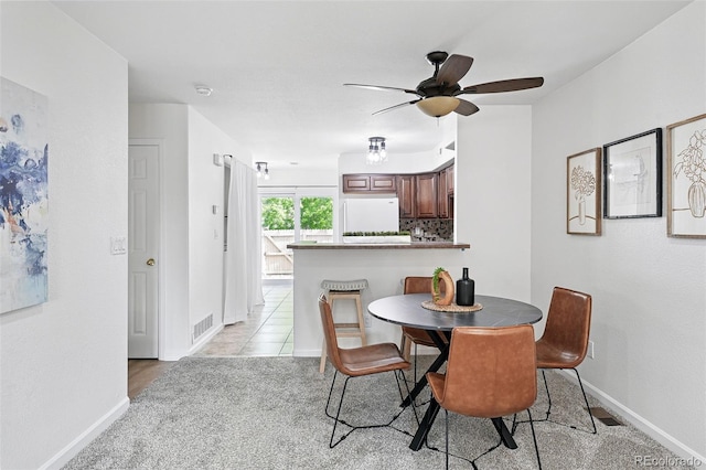 3300 W Florida Ave Unit 117, Denver, CO 80219 - dining space with a ceiling fan and baseboards