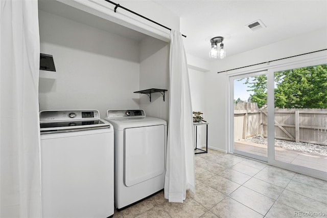 3300 W Florida Ave Unit 117, Denver, CO 80219 - laundry room featuring washing machine and dryer, light tile patterned floors, and baseboards