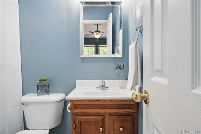 3300 W Florida Ave Unit 117, Denver, CO 80219 - bathroom with vanity, toilet, and ceiling fan