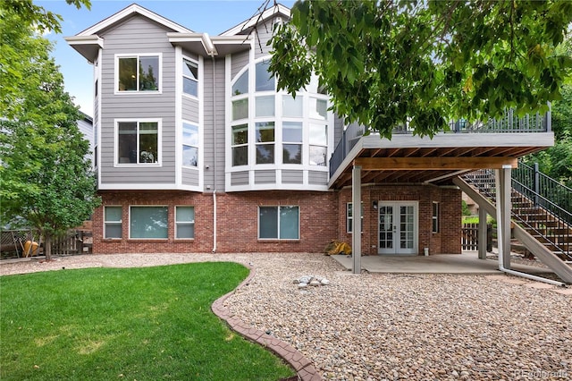 rear view of house featuring french doors, a patio area, and a yard