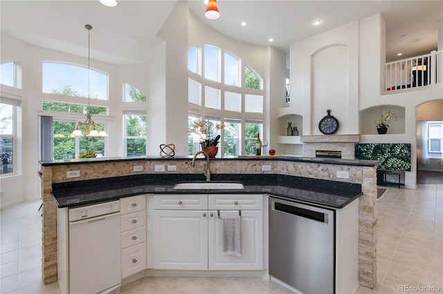 kitchen featuring light tile patterned floors, white cabinets, white dishwasher, and dishwasher