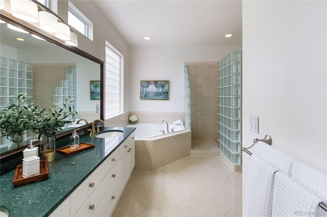 bathroom featuring tile patterned floors, double sink vanity, tiled bath, and radiator