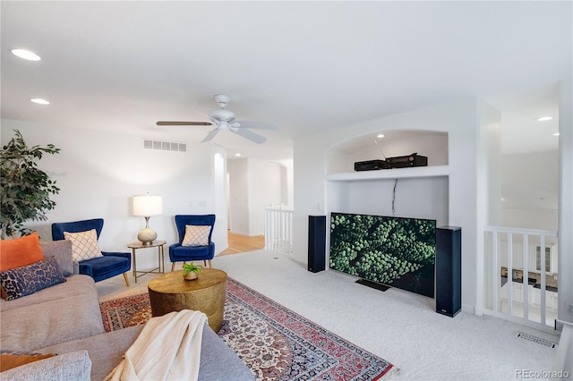 carpeted living room featuring ceiling fan