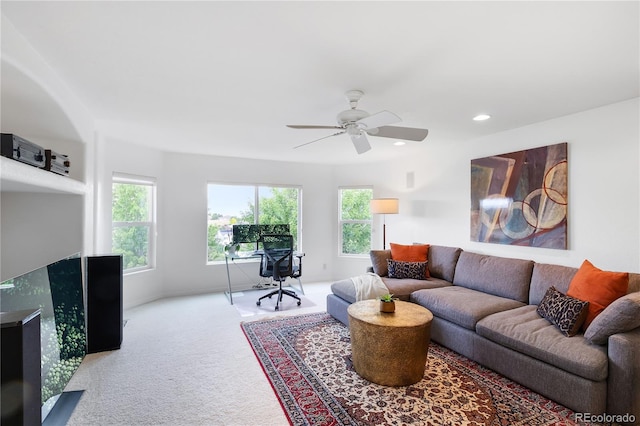 carpeted living room featuring ceiling fan