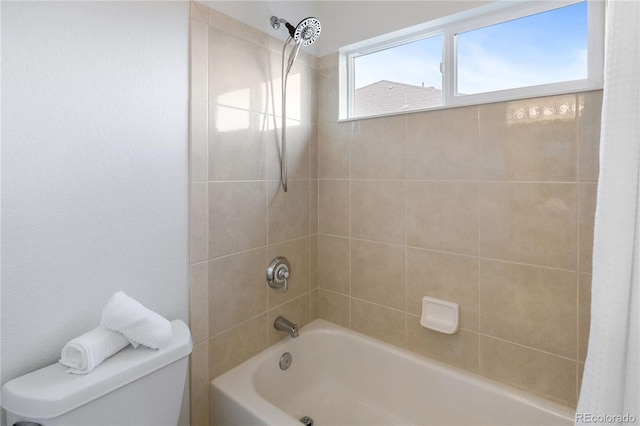 bathroom featuring shower / bath combination with curtain and toilet