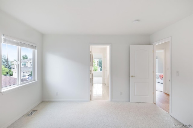 carpeted spare room with a wealth of natural light