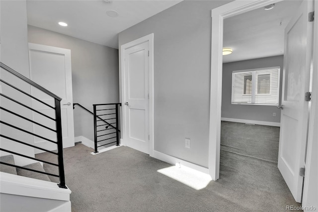 staircase with baseboards and carpet