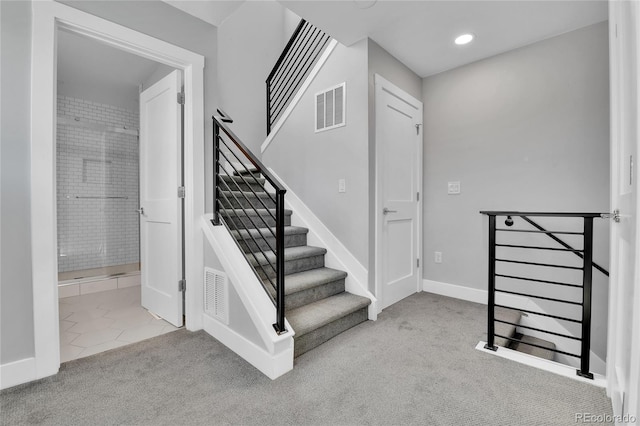 staircase with recessed lighting, baseboards, visible vents, and carpet floors