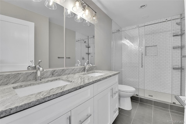 bathroom featuring double vanity, tile patterned flooring, a shower stall, and a sink