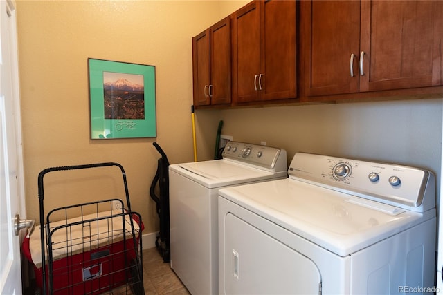 laundry area with cabinets and washer and clothes dryer