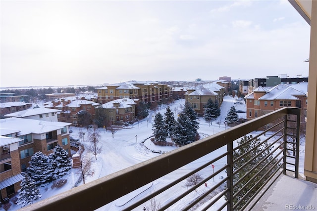 view of snow covered back of property