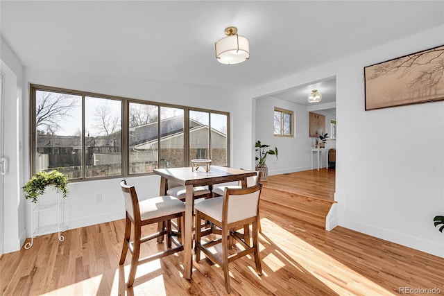 dining space featuring wood-type flooring